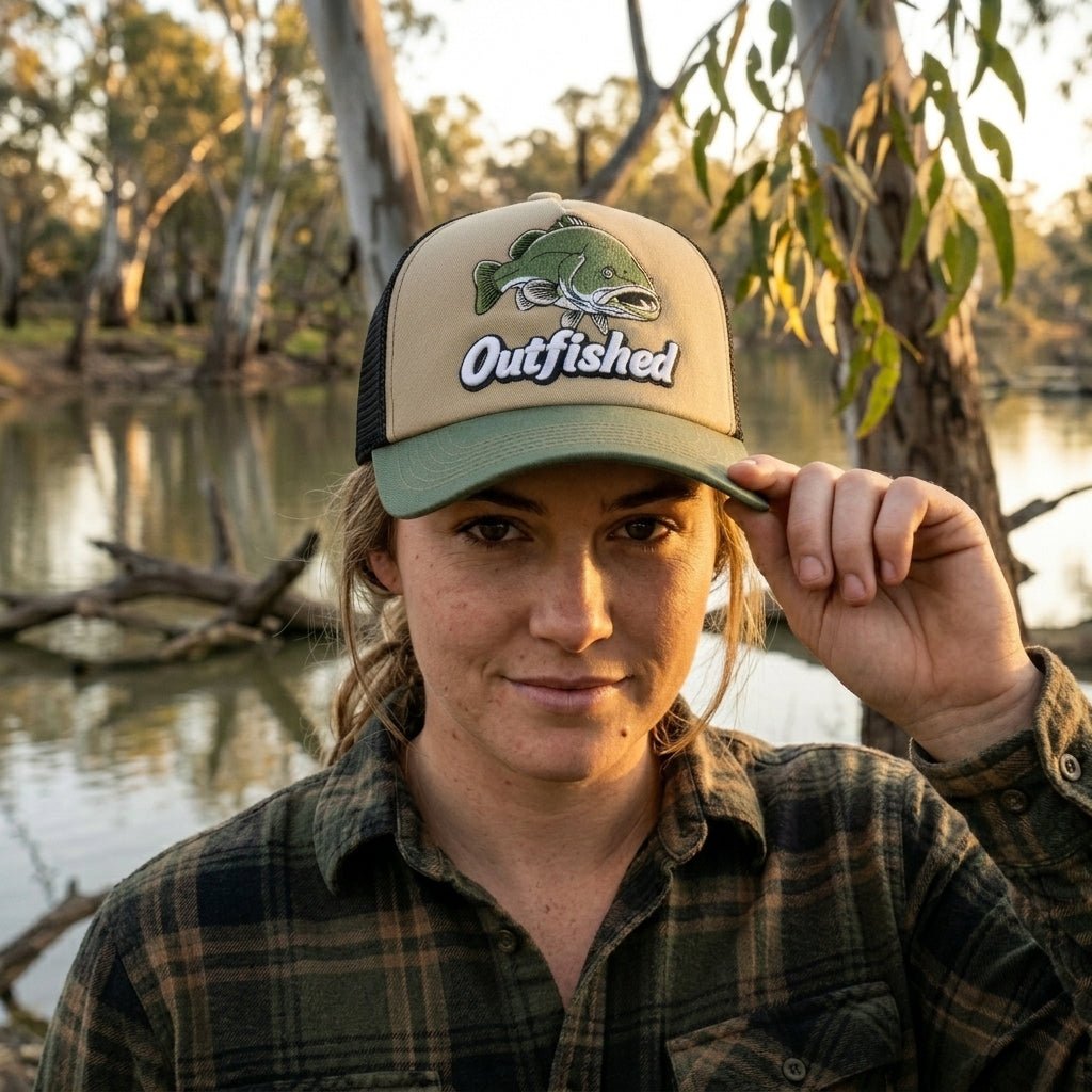 Woman wearing The Goodoo Murray cod fishing cap by an inland Australian river