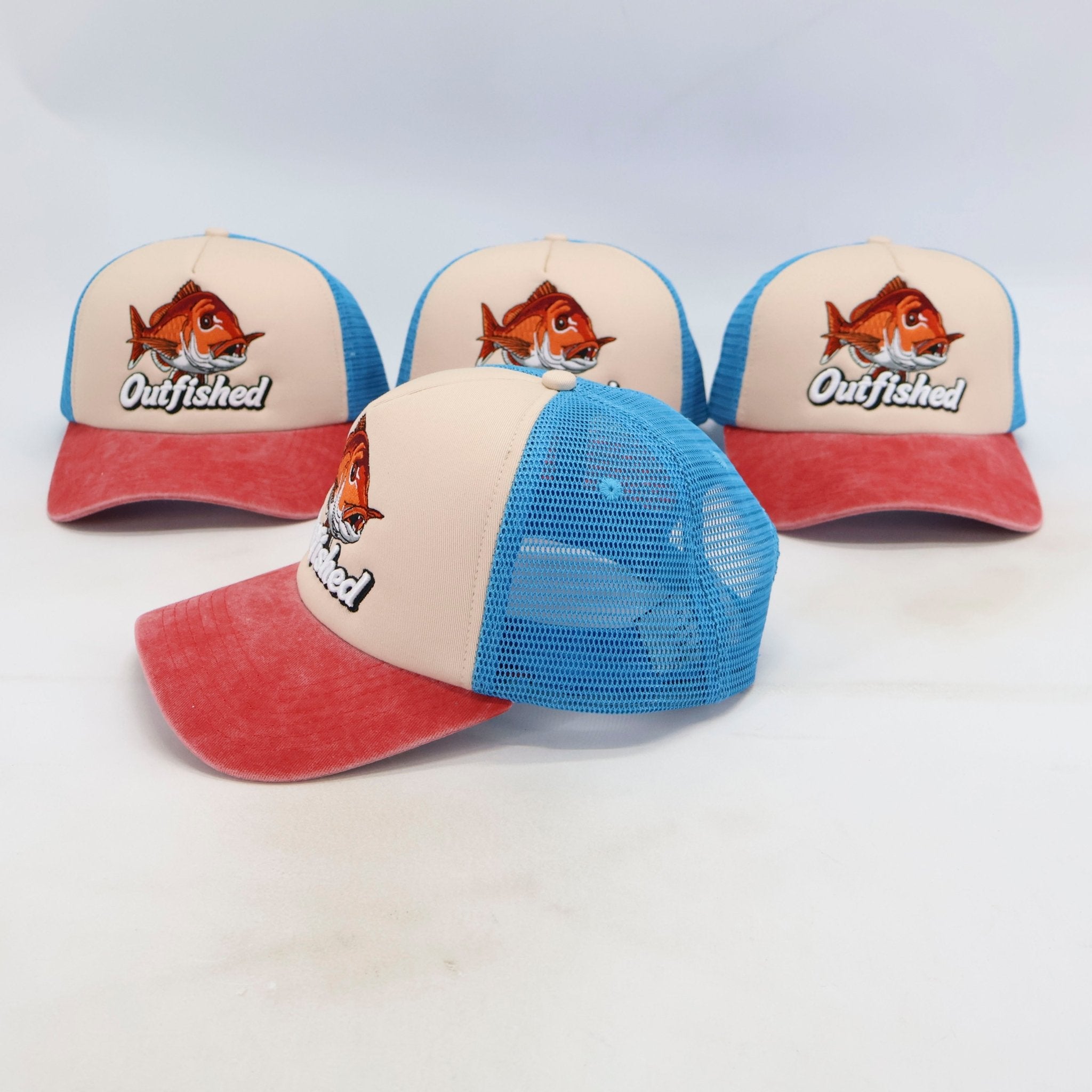 Four Knobby snapper fishing trucker caps showing front and breathable mesh back
